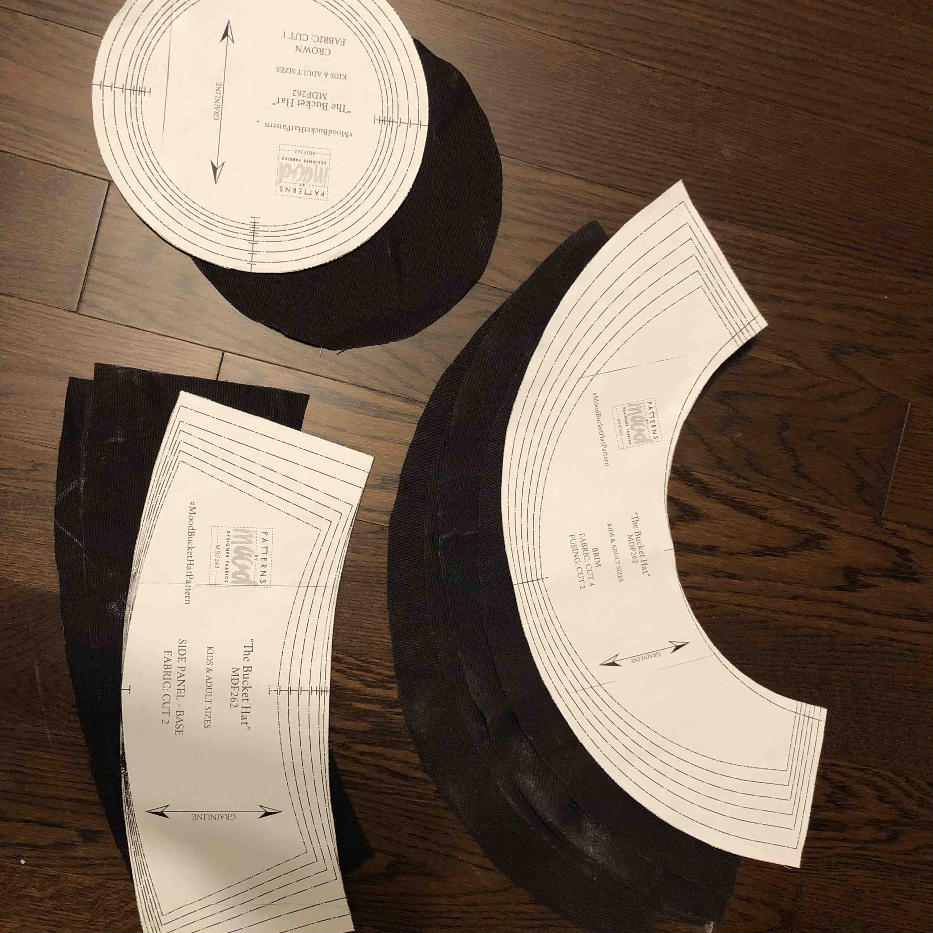 Image of paper pattern pieces of black sunhat.