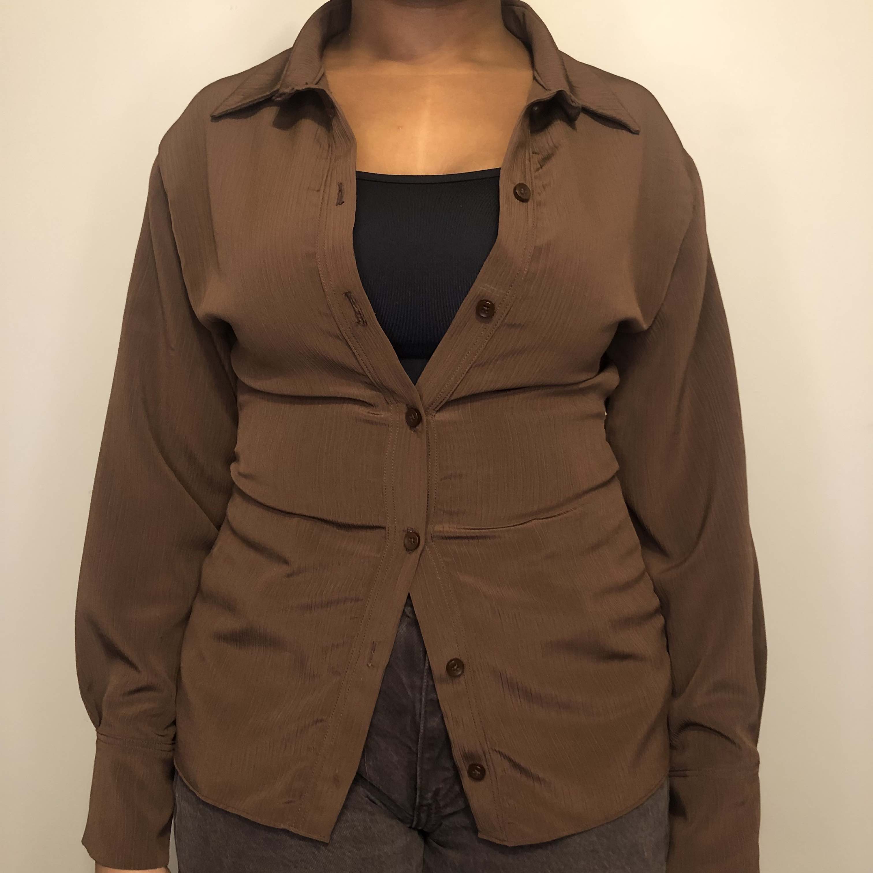 Image of brown button-up shirt.